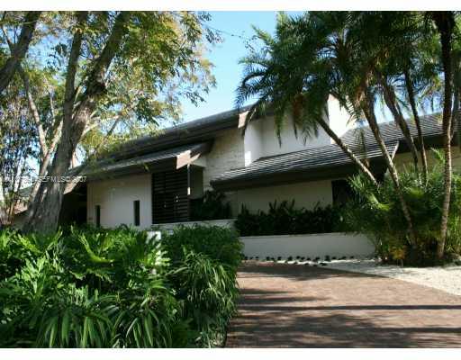 700 Lake Road Miami, FL 33137 - Photo 2 of 12 a yellow house with trees in front of it