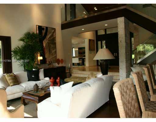 700 Lake Road Miami, FL 33137 - Photo 3 of 12 a living room with furniture a flat screen tv and a fireplace