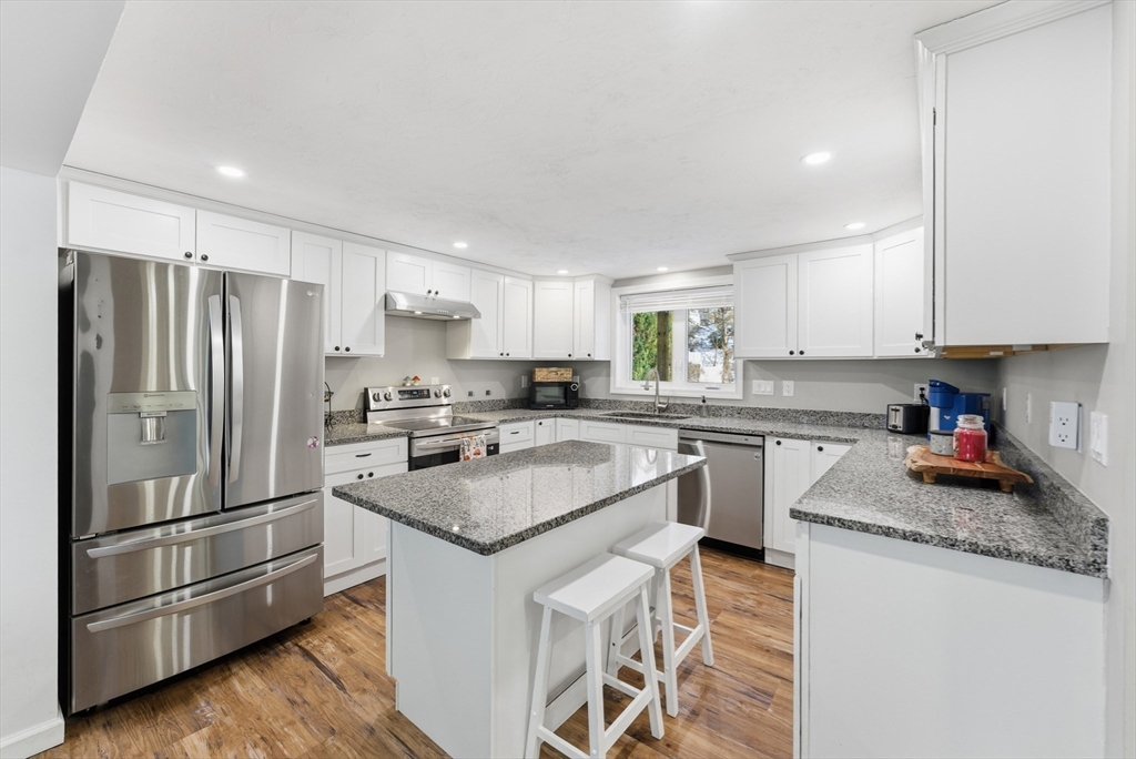160 Cottage Street Athol, MA 01331 - Photo 4 of 35 a kitchen with stainless steel appliances granite countertop a refrigerator a sink a stove a microwave and island