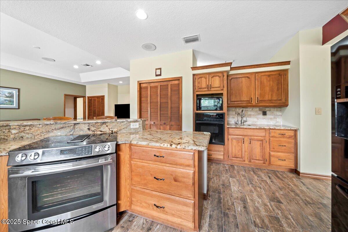 223 Deer Run Road Palm Bay, FL 32909 - Photo 7 of 41 a kitchen with a stove oven and sink