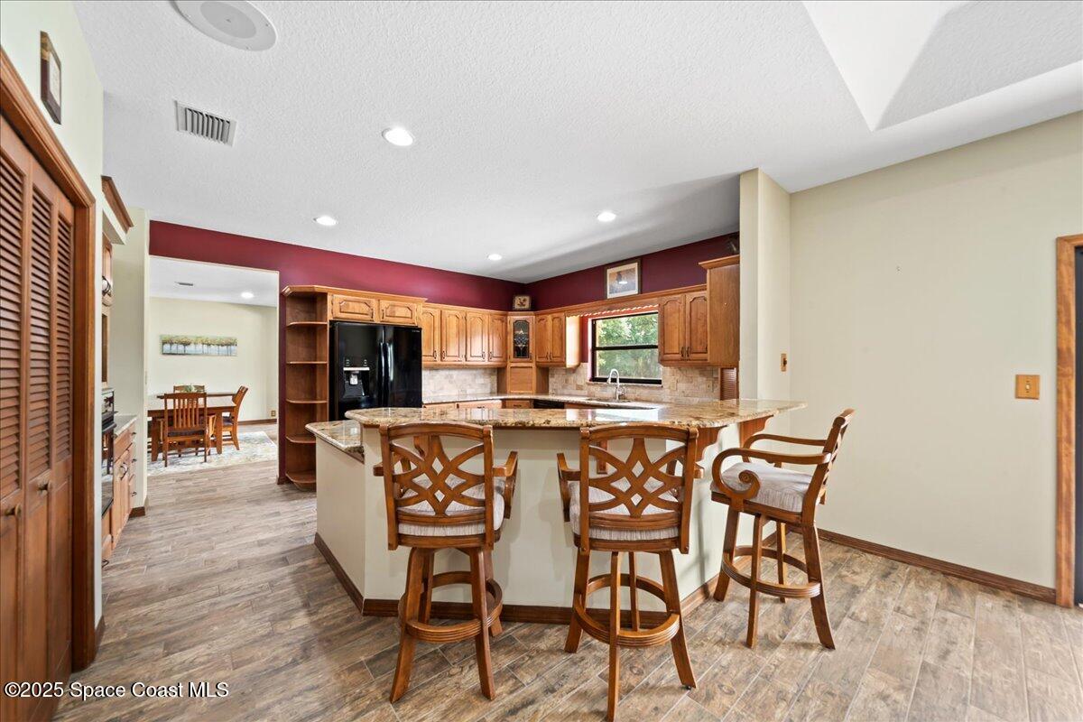 223 Deer Run Road Palm Bay, FL 32909 - Photo 8 of 41 a view of a dining room with furniture window and wooden floor