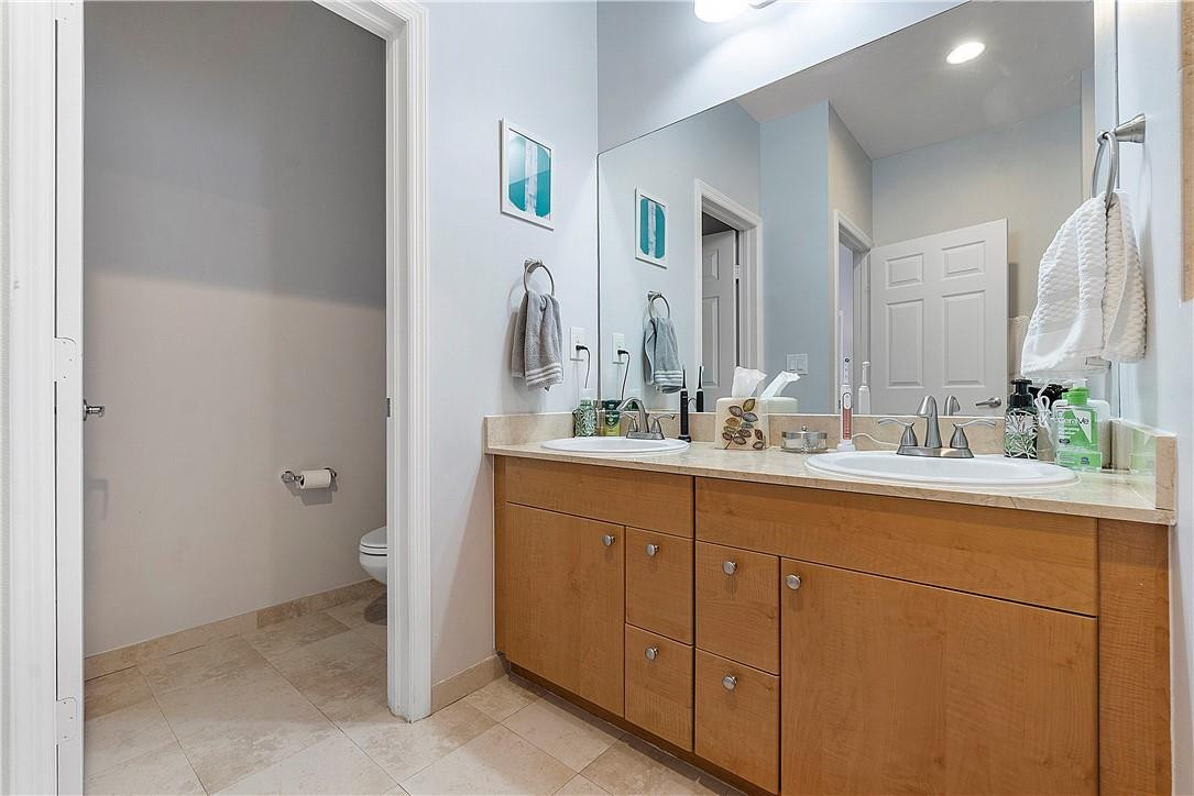 2330 Vintage Drive Lighthouse Point, FL 33064 - Photo 22 of 41 a bathroom with a double vanity sink and a mirror