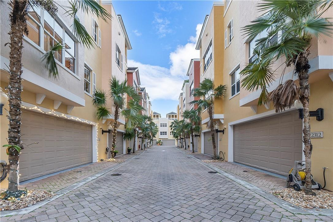 2330 Vintage Drive Lighthouse Point, FL 33064 - Photo 3 of 41 a view of a house with a yard and garage