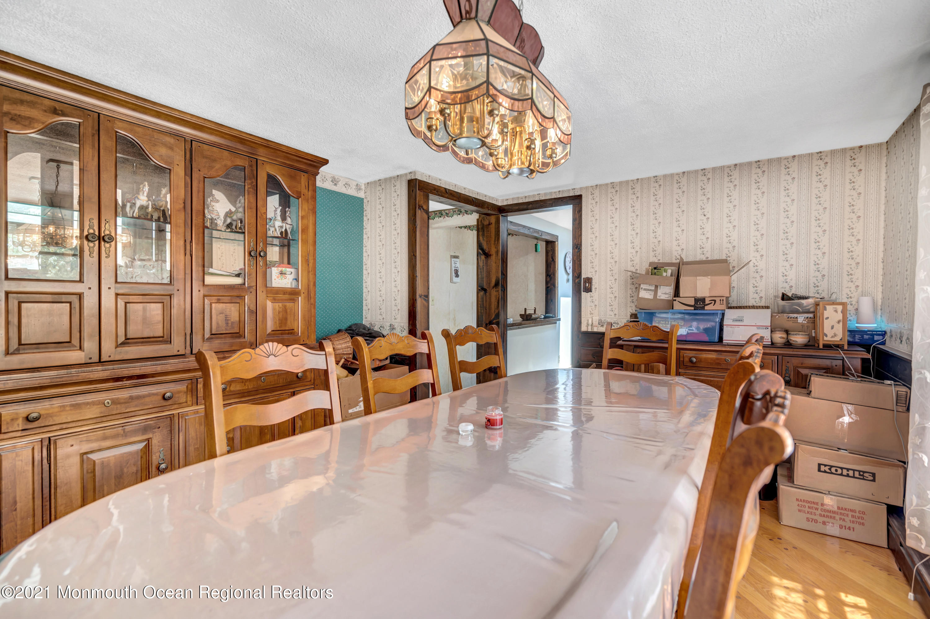 580 Hyson Road Jackson, NJ 08527 - Photo 19 of 45 a dining hall with couches a dining table and chairs with wooden floor
