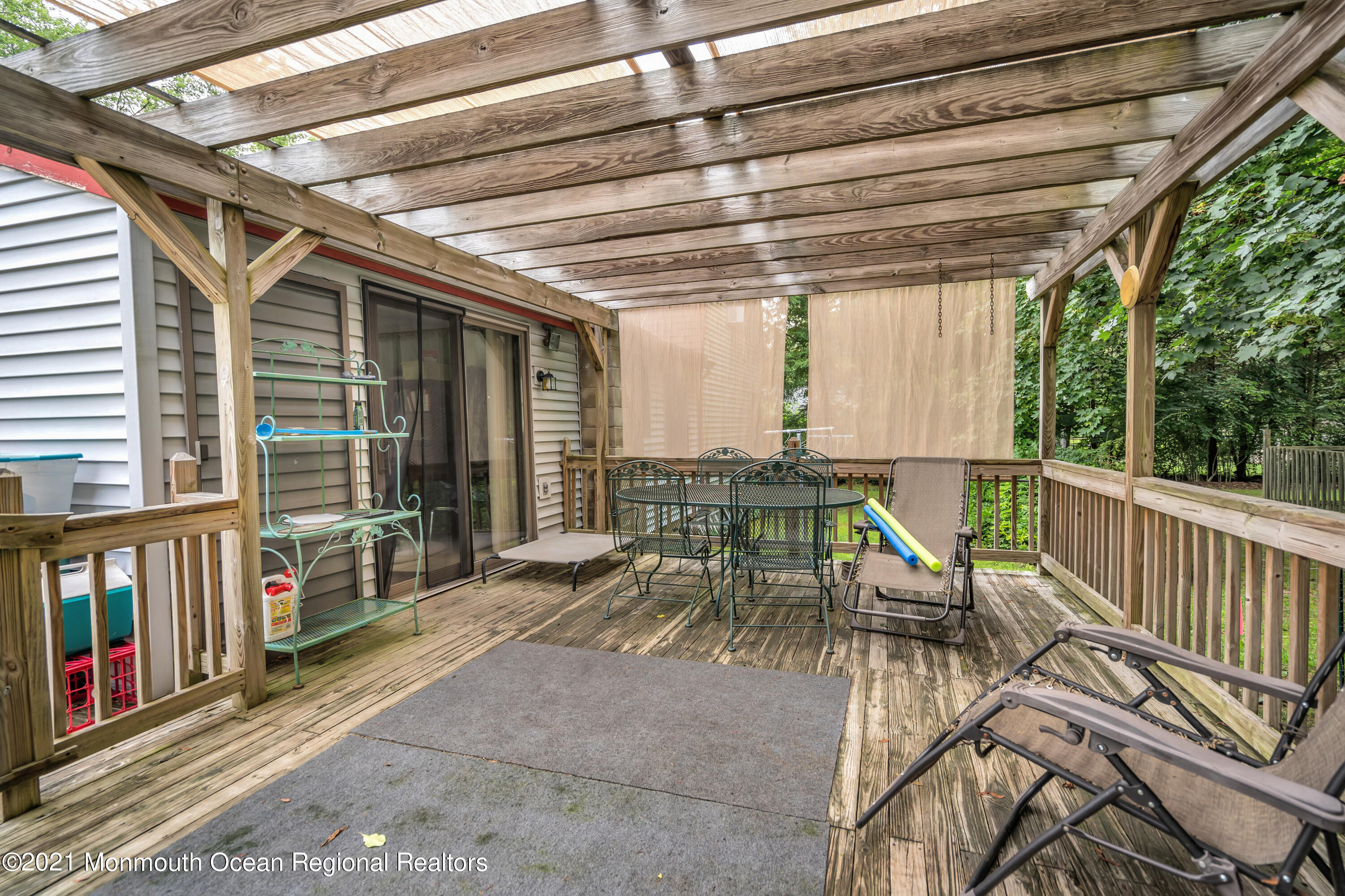 580 Hyson Road Jackson, NJ 08527 - Photo 23 of 45 a view of a patio with a table chairs and wooden floor
