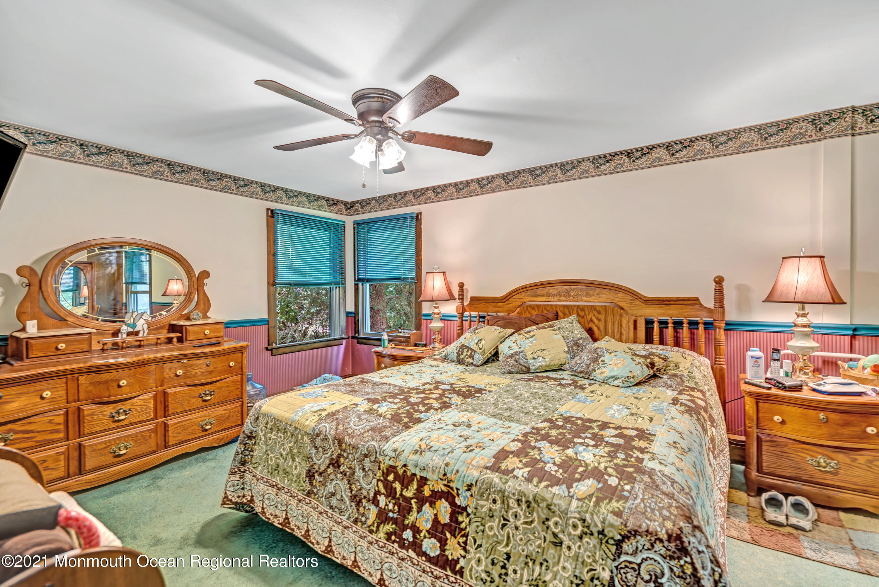 580 Hyson Road Jackson, NJ 08527 - Photo 38 of 45 a bedroom with a bed a chandelier and dresser