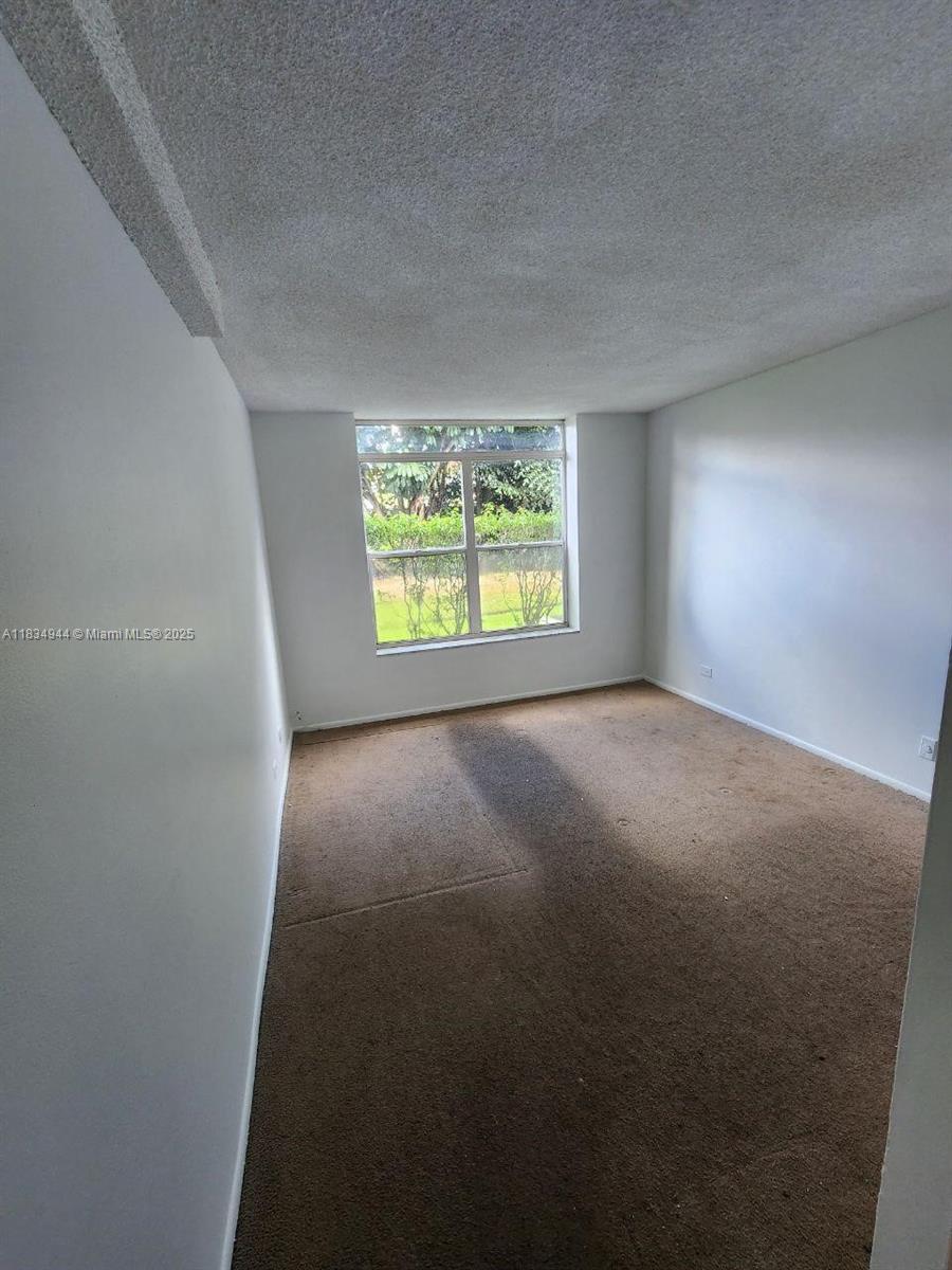 3690 Inverrary Drive, Unit 1T Lauderhill, FL 33319 - Photo 11 of 24 an empty room with windows