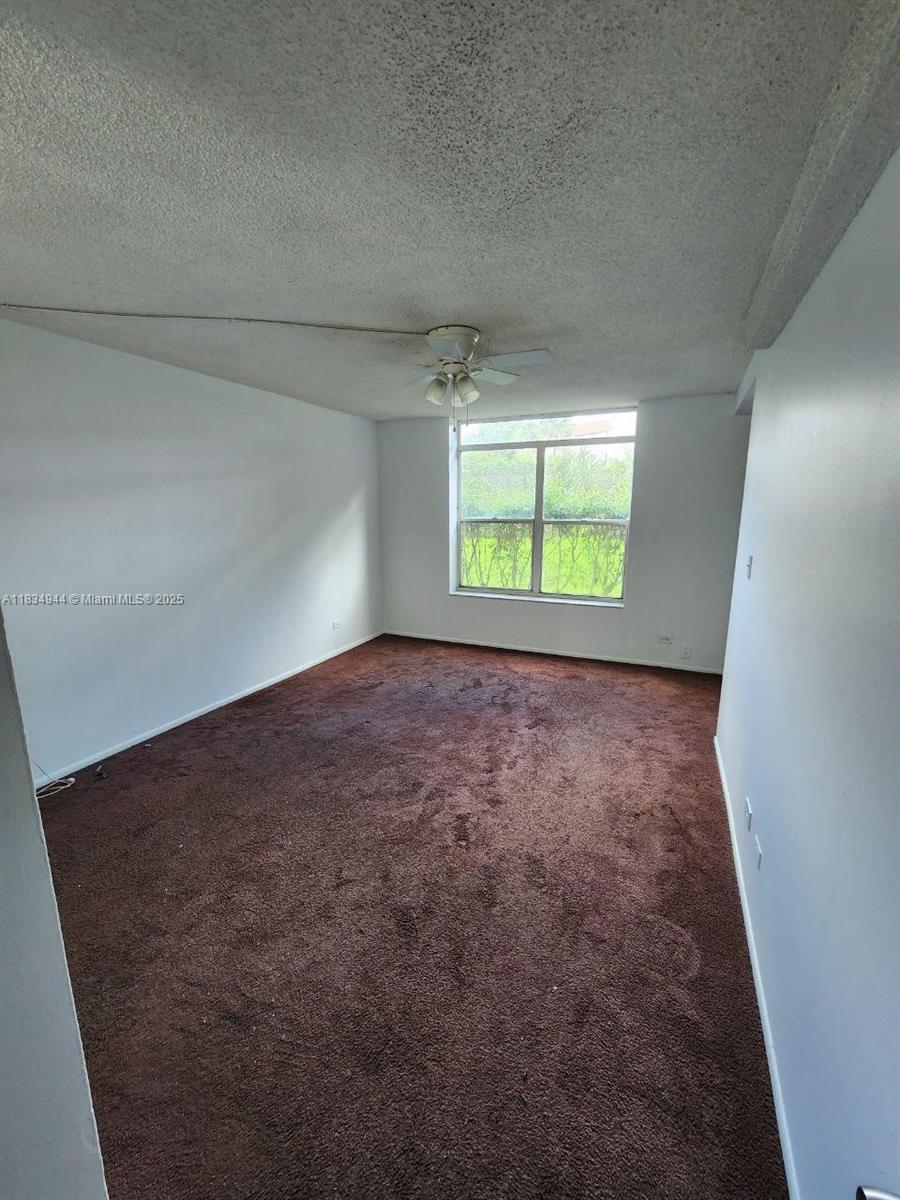 3690 Inverrary Drive, Unit 1T Lauderhill, FL 33319 - Photo 13 of 24 an empty room with a window