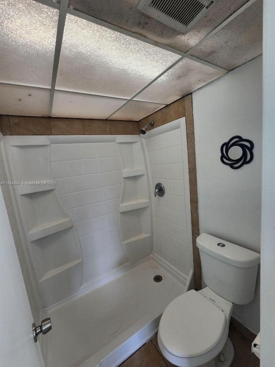 3690 Inverrary Drive, Unit 1T Lauderhill, FL 33319 - Photo 16 of 24 a white toilet sitting next to a bath tub
