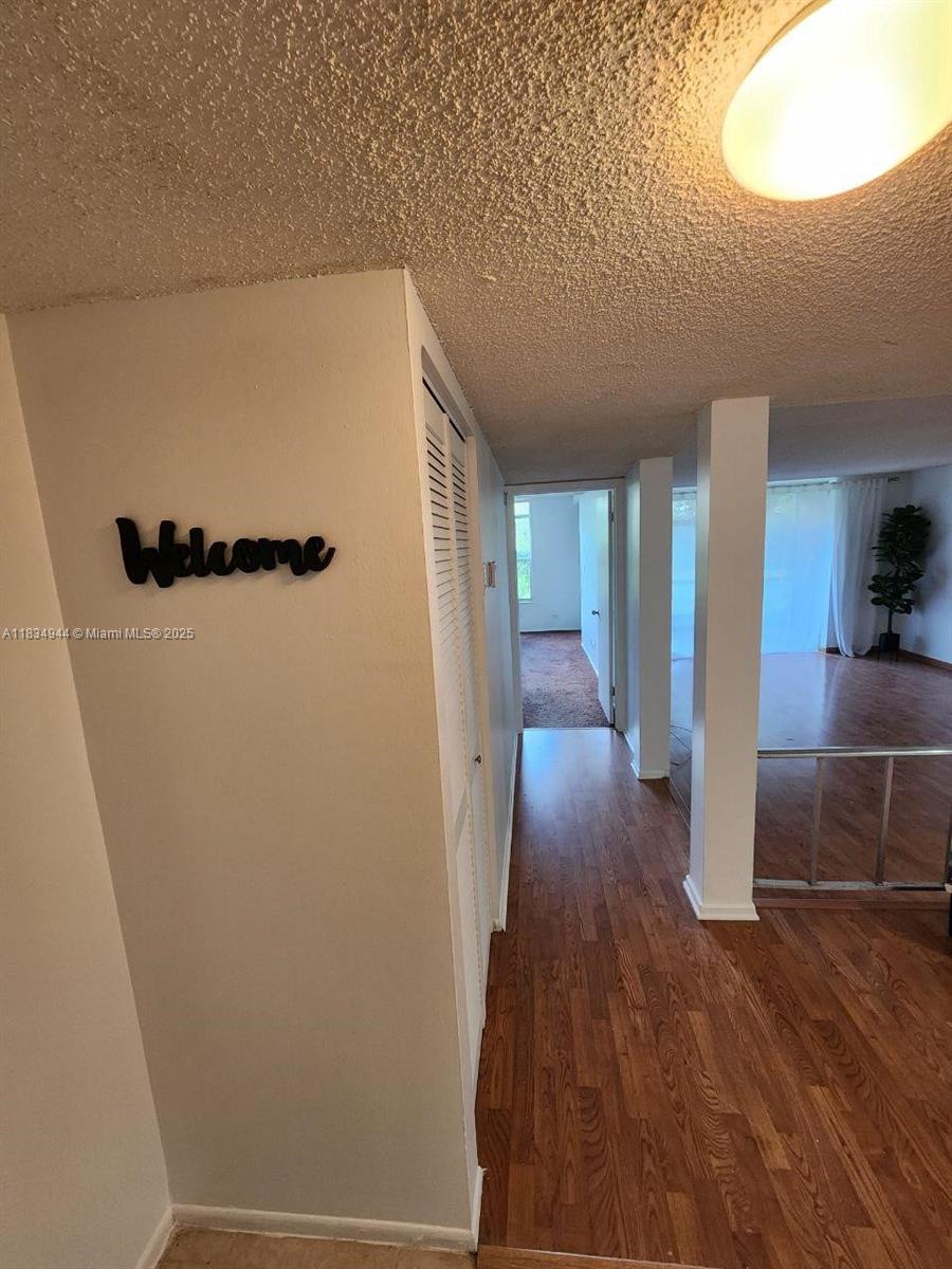 3690 Inverrary Drive, Unit 1T Lauderhill, FL 33319 - Photo 17 of 24 a view of entryway with wooden floor