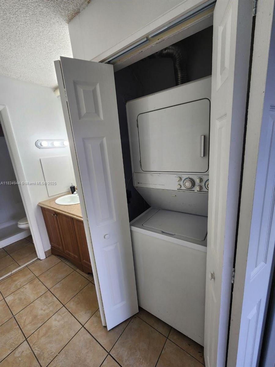 3690 Inverrary Drive, Unit 1T Lauderhill, FL 33319 - Photo 18 of 24 a utility room with dryer and washer