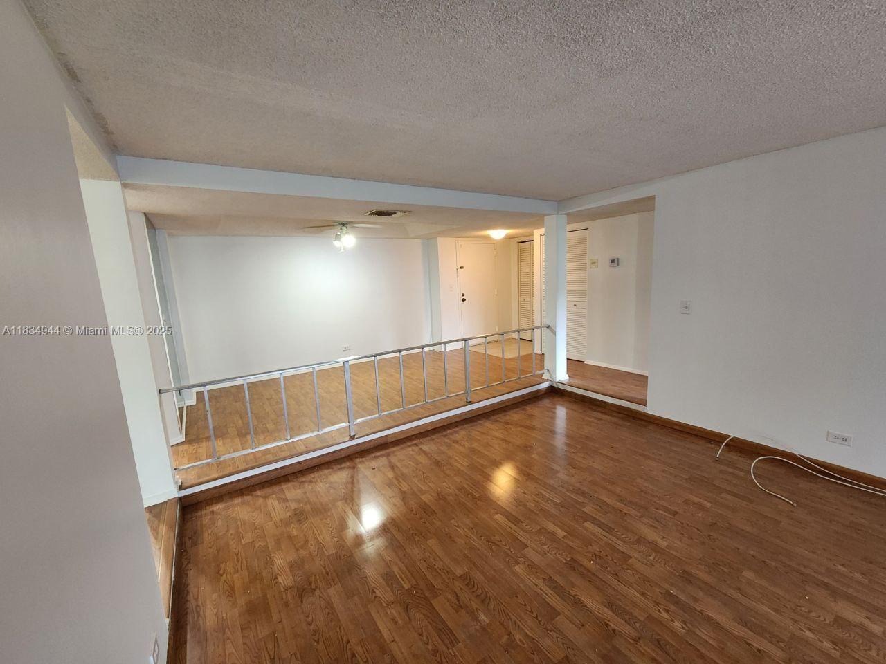 3690 Inverrary Drive, Unit 1T Lauderhill, FL 33319 - Photo 20 of 24 a view of an empty room with wooden floor