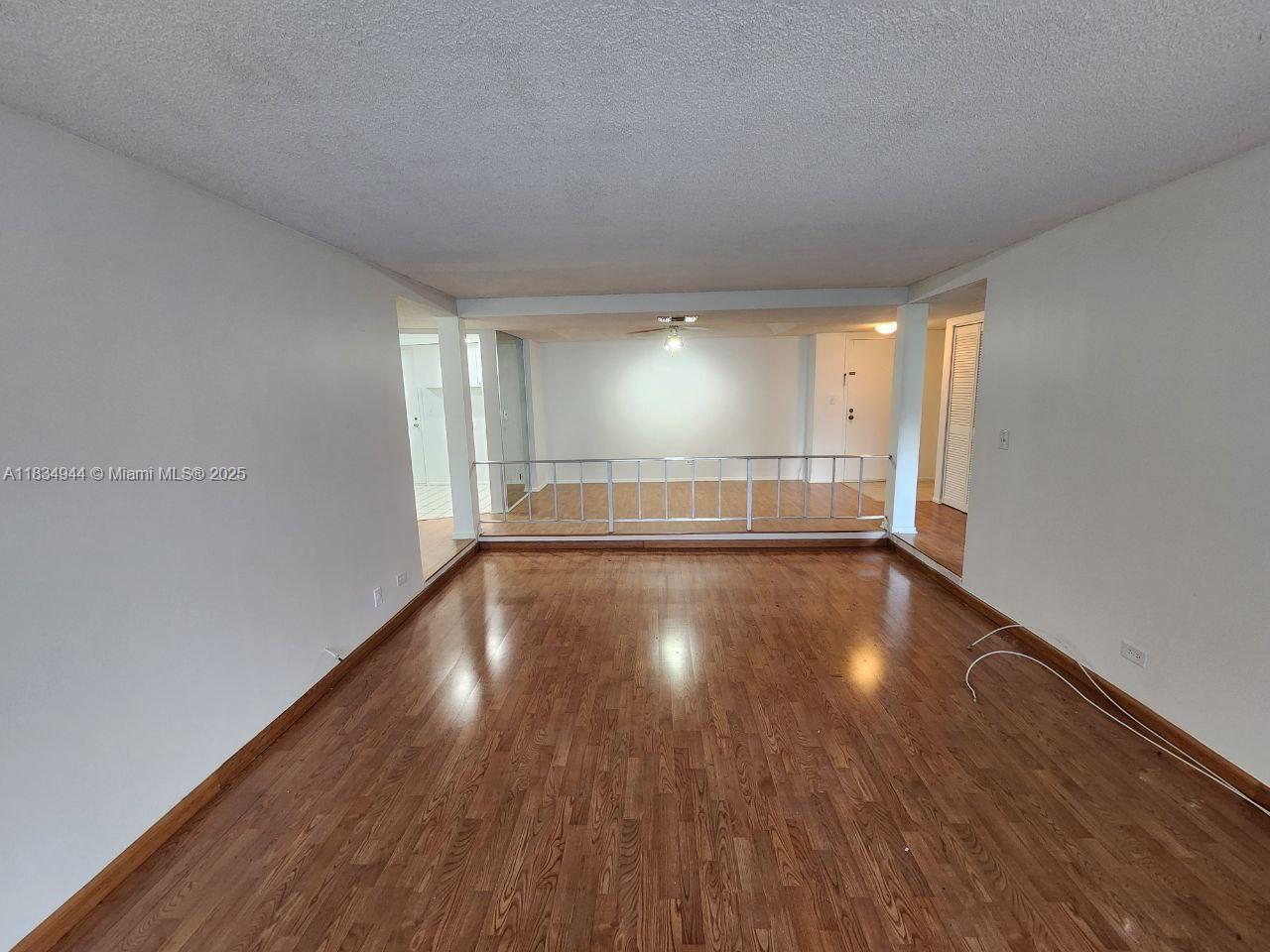3690 Inverrary Drive, Unit 1T Lauderhill, FL 33319 - Photo 21 of 24 a view of empty room with wooden floor