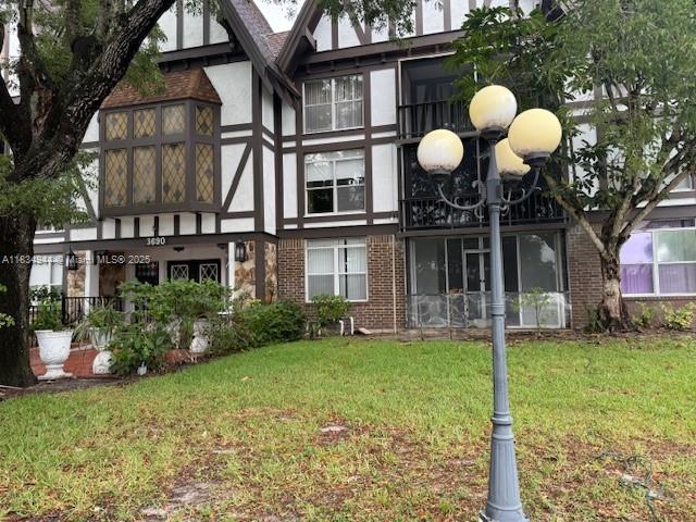 3690 Inverrary Drive, Unit 1T Lauderhill, FL 33319 - Photo 9 of 24 a view of a house with a backyard and porch