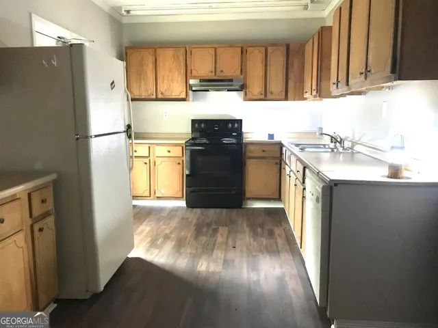 a kitchen with a refrigerator and a sink