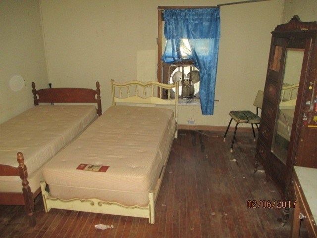2661 New Clinton Road, Unit B17 Macon, GA 31211 - Photo 7 of 10 a bed sitting in a bedroom next to a window