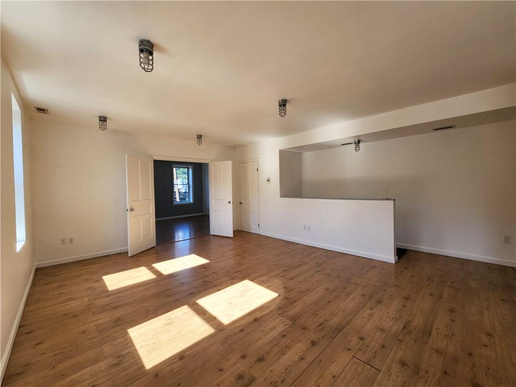 5326 Butler Street, Unit 3 Pittsburgh, PA 15201 - Photo 3 of 6 a view of a big room with wooden floor and windows