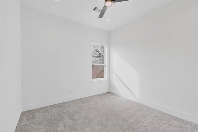 a view of a room with a ceiling fan