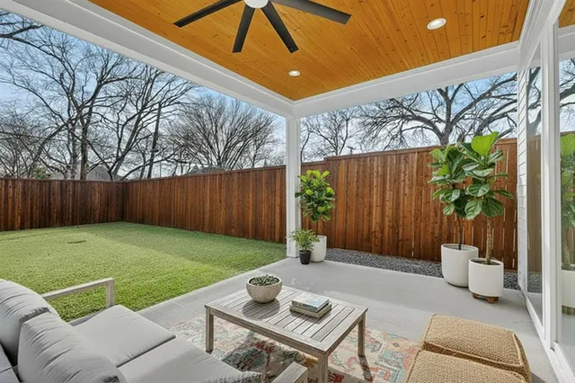 a view of a backyard with wooden fence