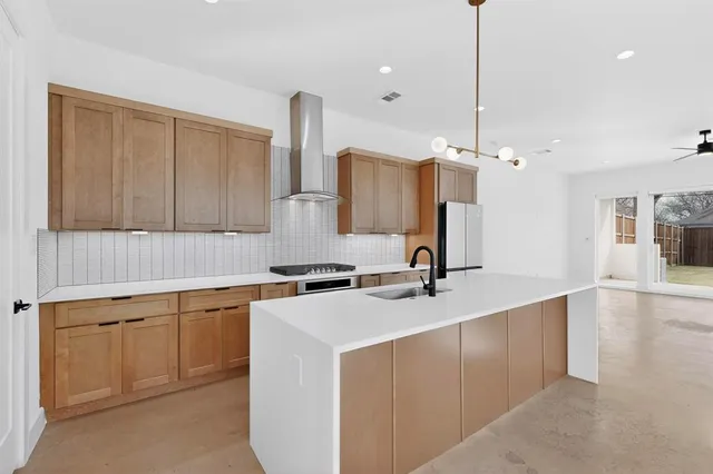 a kitchen with appliances and a sink