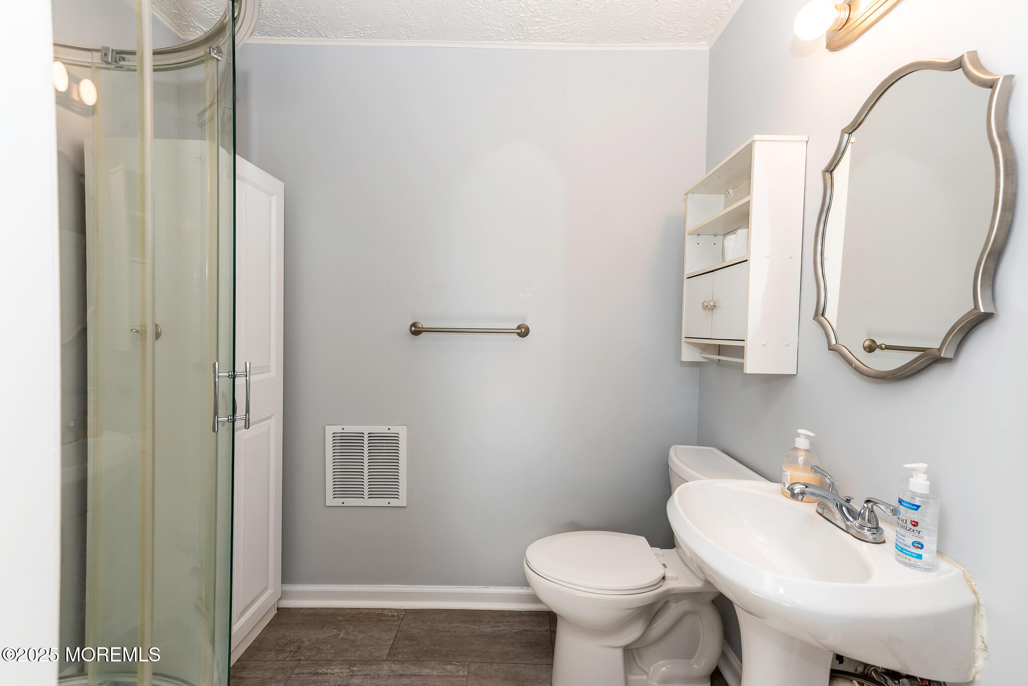 112 Ocean Gate Avenue Ocean Gate, NJ 08740 - Photo 10 of 15 a bathroom with a sink toilet and a mirror