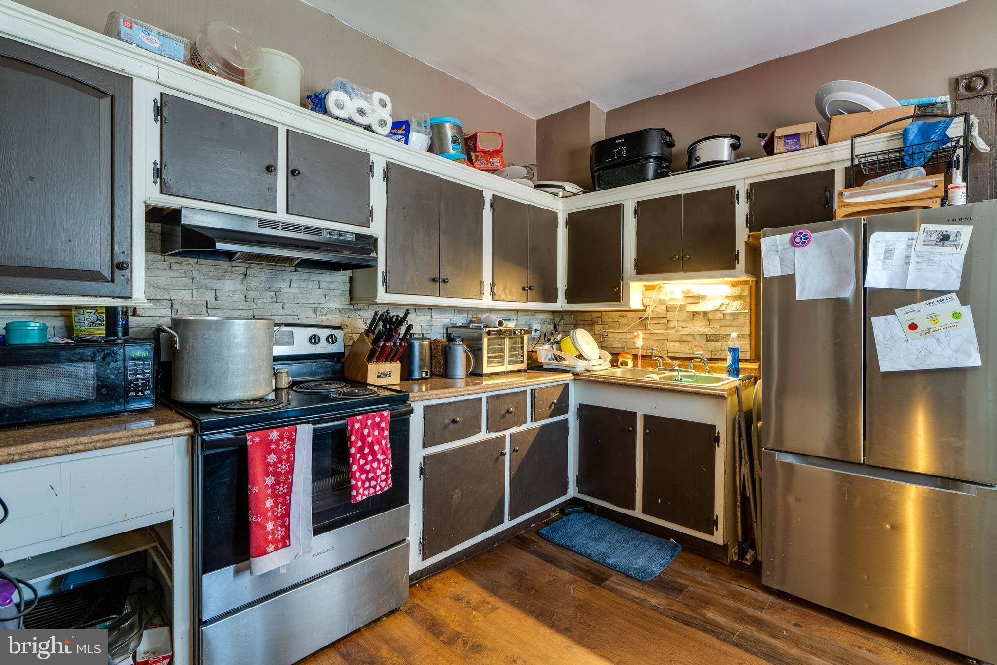546 Poplar Street Lancaster, PA 17603 - Photo 14 of 29 a kitchen with stainless steel appliances granite countertop a stove and a refrigerator