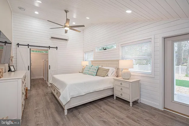 a bedroom with a bed and a large window