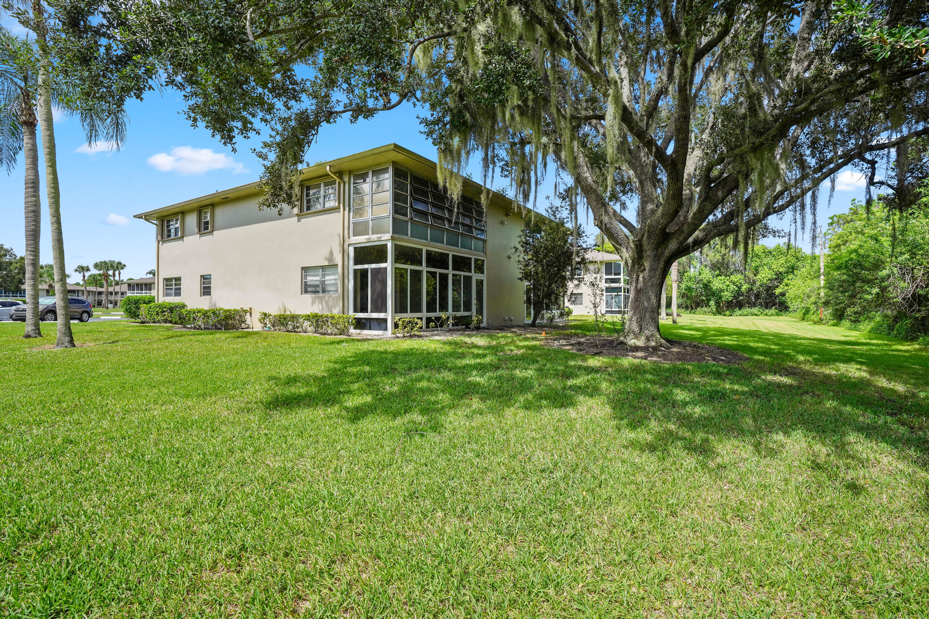 23 Lake Vista Trail, Unit 101 Port St. Lucie, FL 34952 - Photo 20 of 24 a view of a house with a yard