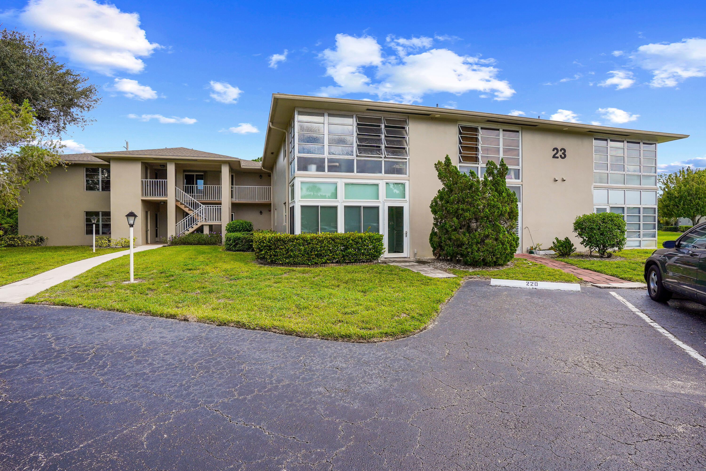 23 Lake Vista Trail, Unit 101 Port St. Lucie, FL 34952 - Photo 4 of 24 a view of a house with backyard and a tree
