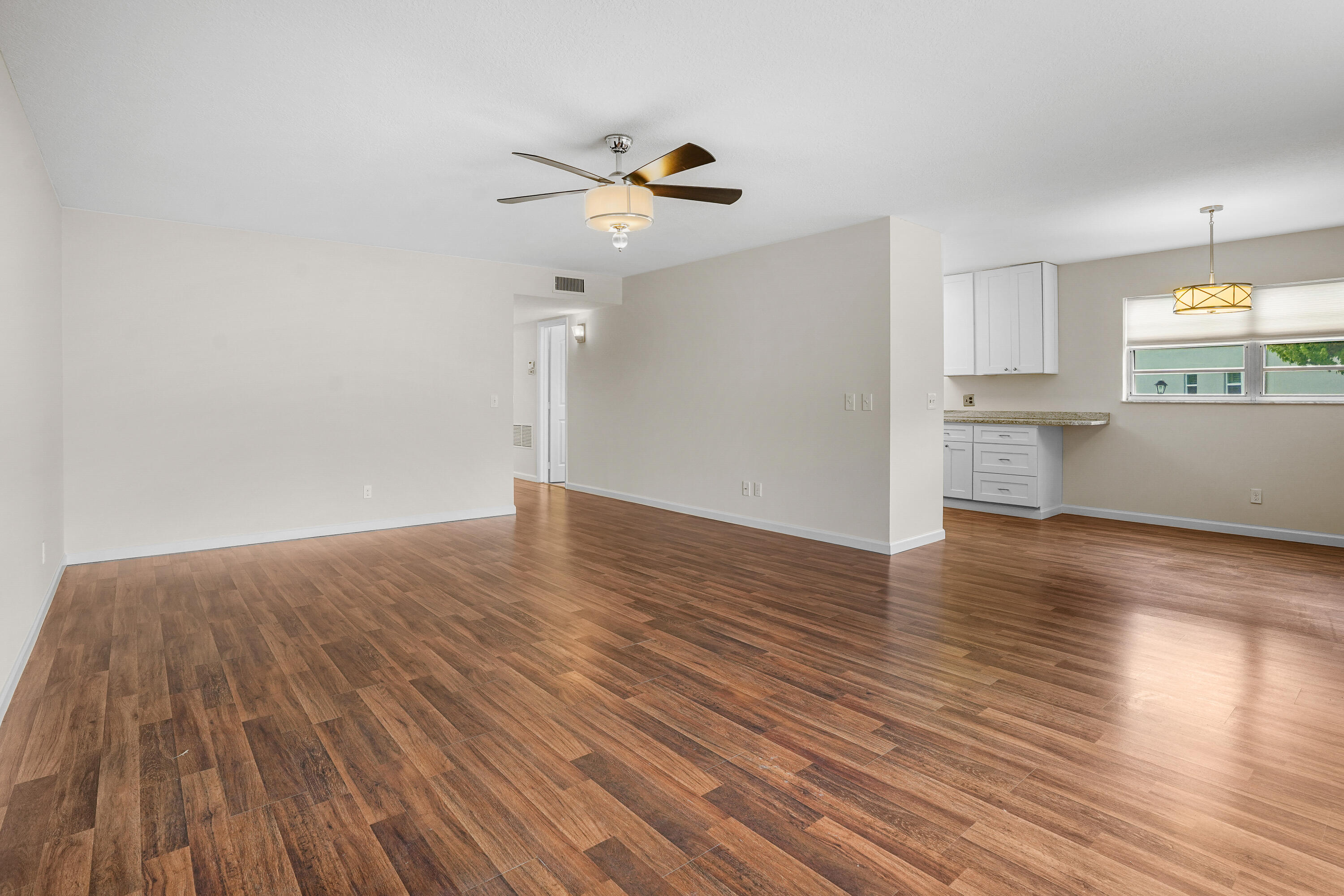 23 Lake Vista Trail, Unit 101 Port St. Lucie, FL 34952 - Photo 6 of 24 a view of empty room with wooden floor and window