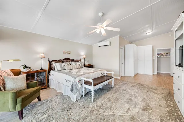 a spacious bathroom with a double vanity sink mirror and a bath tub
