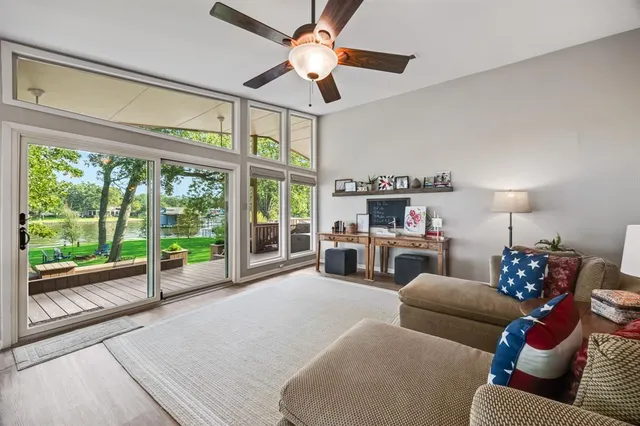 a living room with furniture fireplace and a large window
