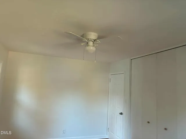 a view of a room with a ceiling fan