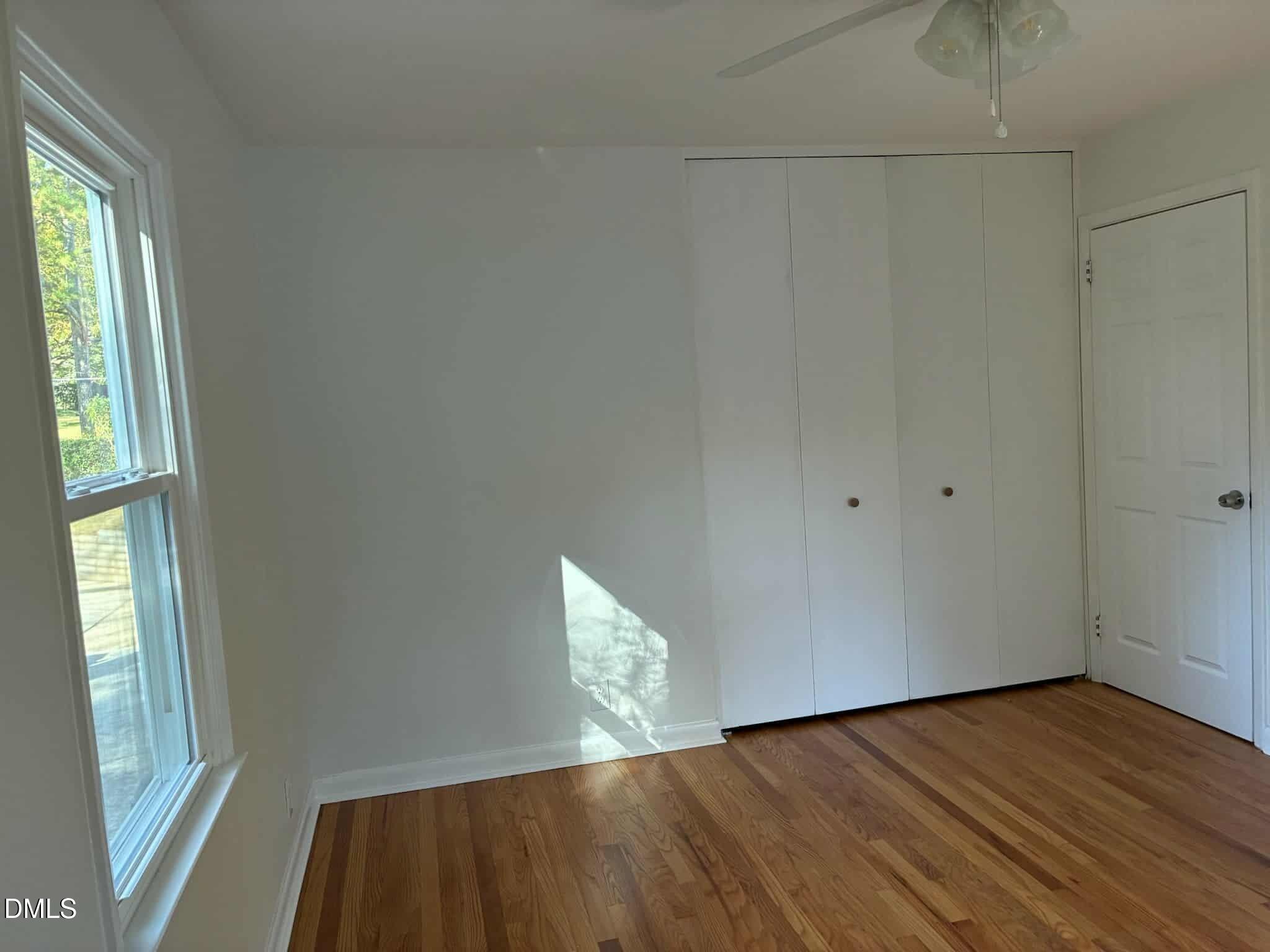 3415 Carolyn Drive Raleigh, NC 27604 - Photo 16 of 30 a view of an empty room with wooden floor and a window
