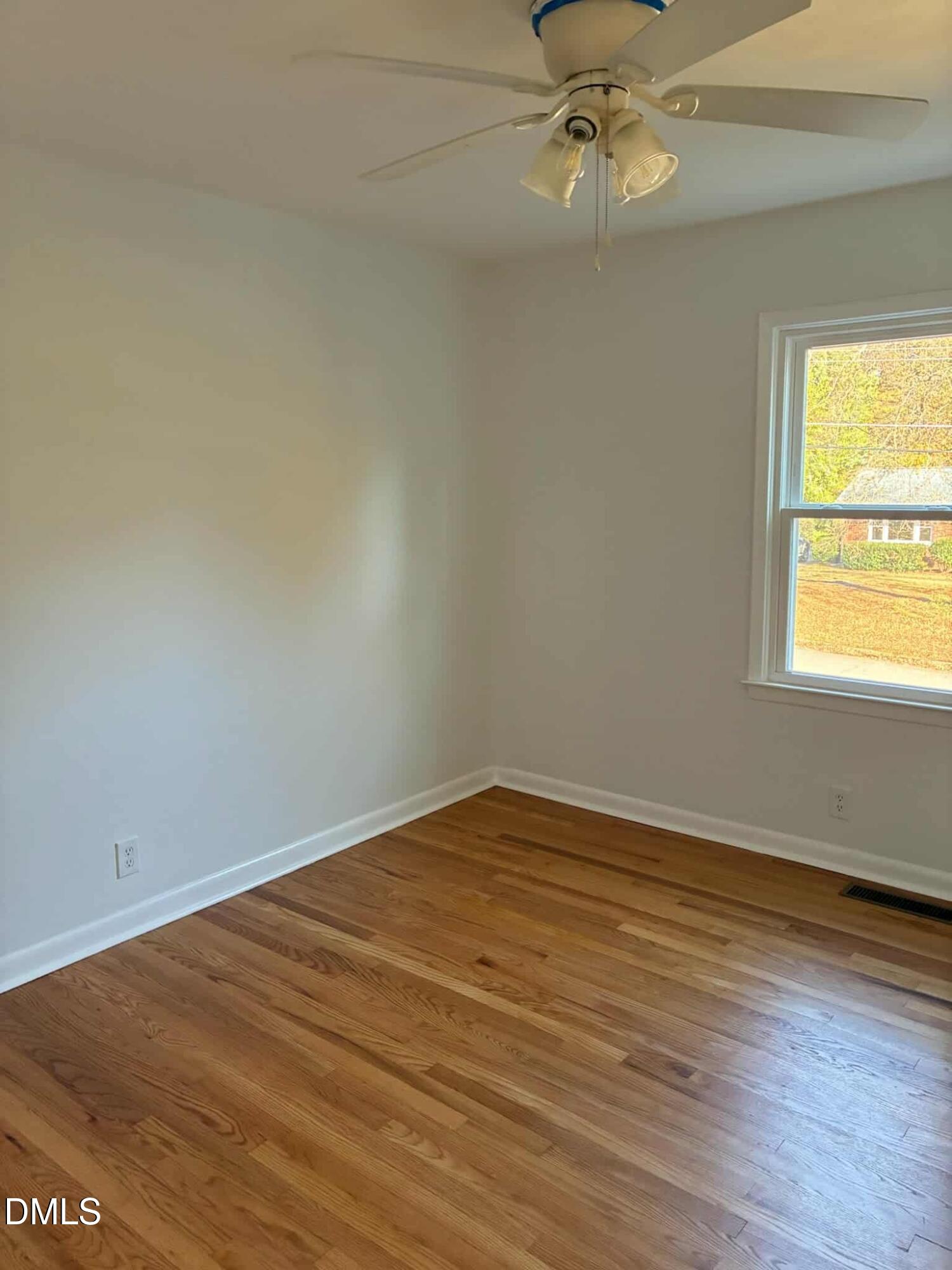 3415 Carolyn Drive Raleigh, NC 27604 - Photo 18 of 30 wooden floor in an empty room with a window