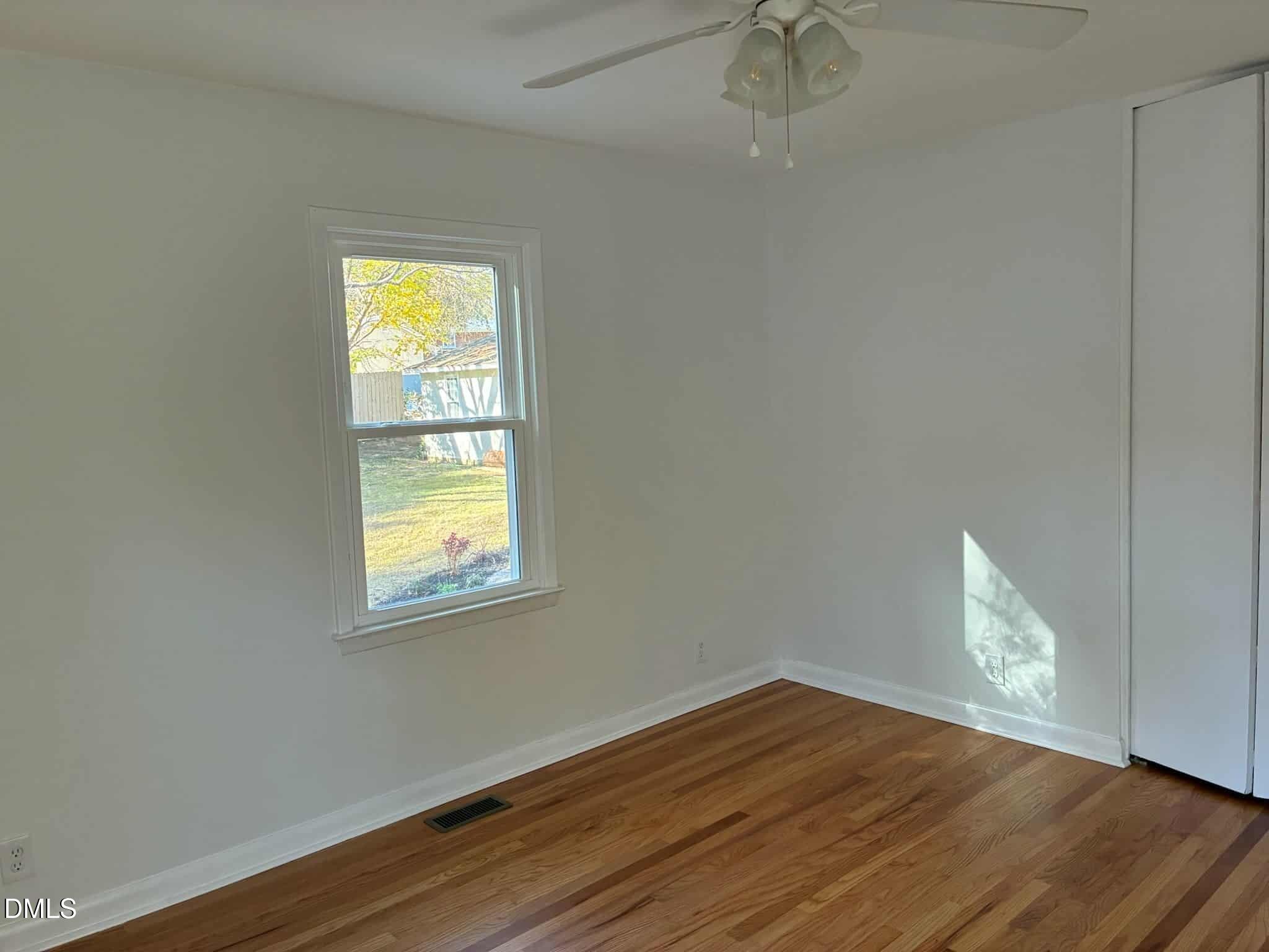 3415 Carolyn Drive Raleigh, NC 27604 - Photo 21 of 30 a view of an empty room with wooden floor and a window
