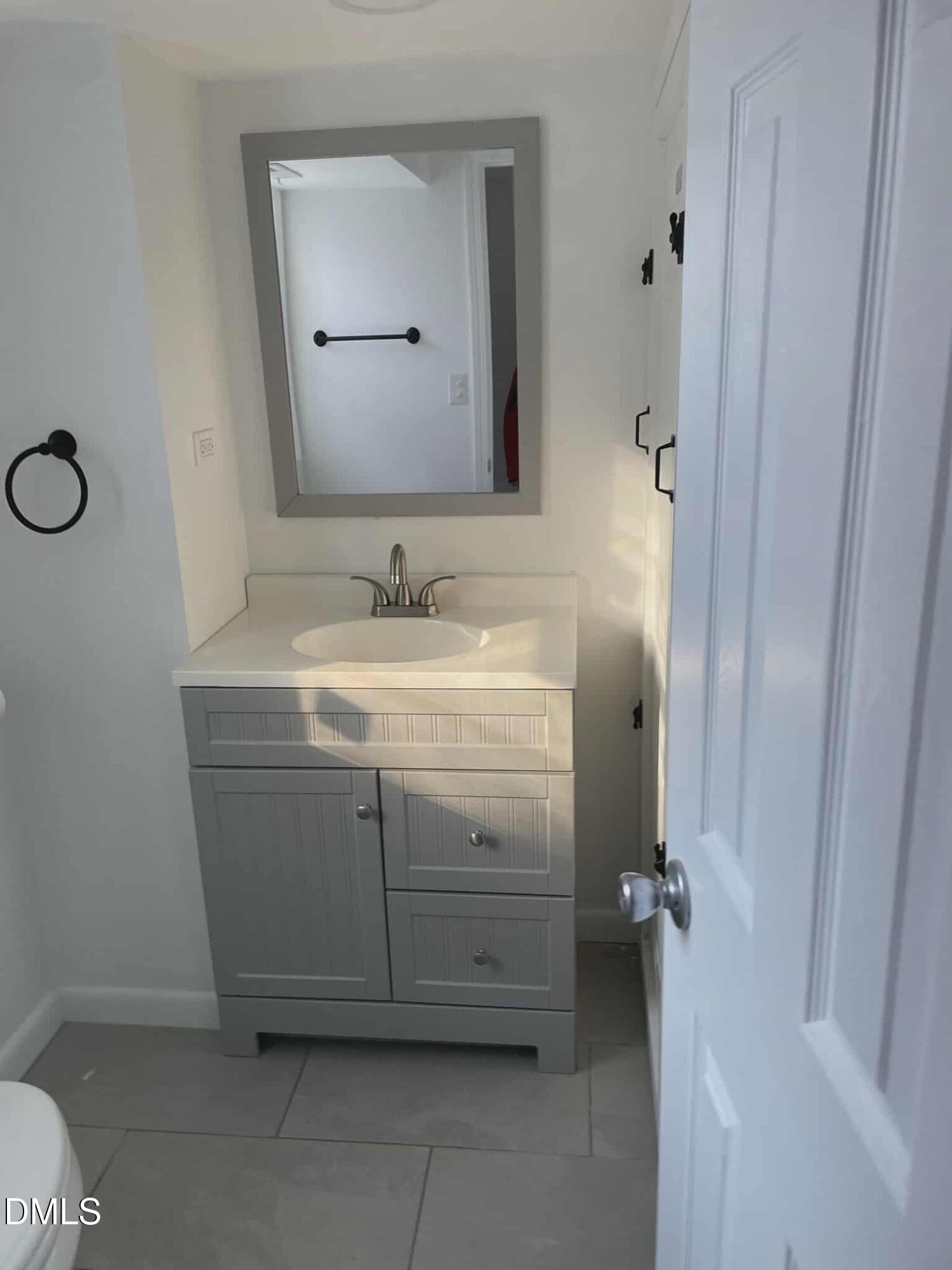 3415 Carolyn Drive Raleigh, NC 27604 - Photo 25 of 30 a bathroom with a sink and a mirror