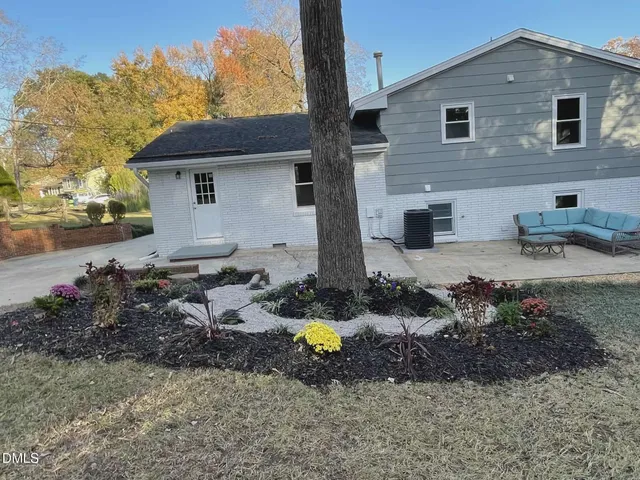 a backyard of a house with yard and outdoor seating