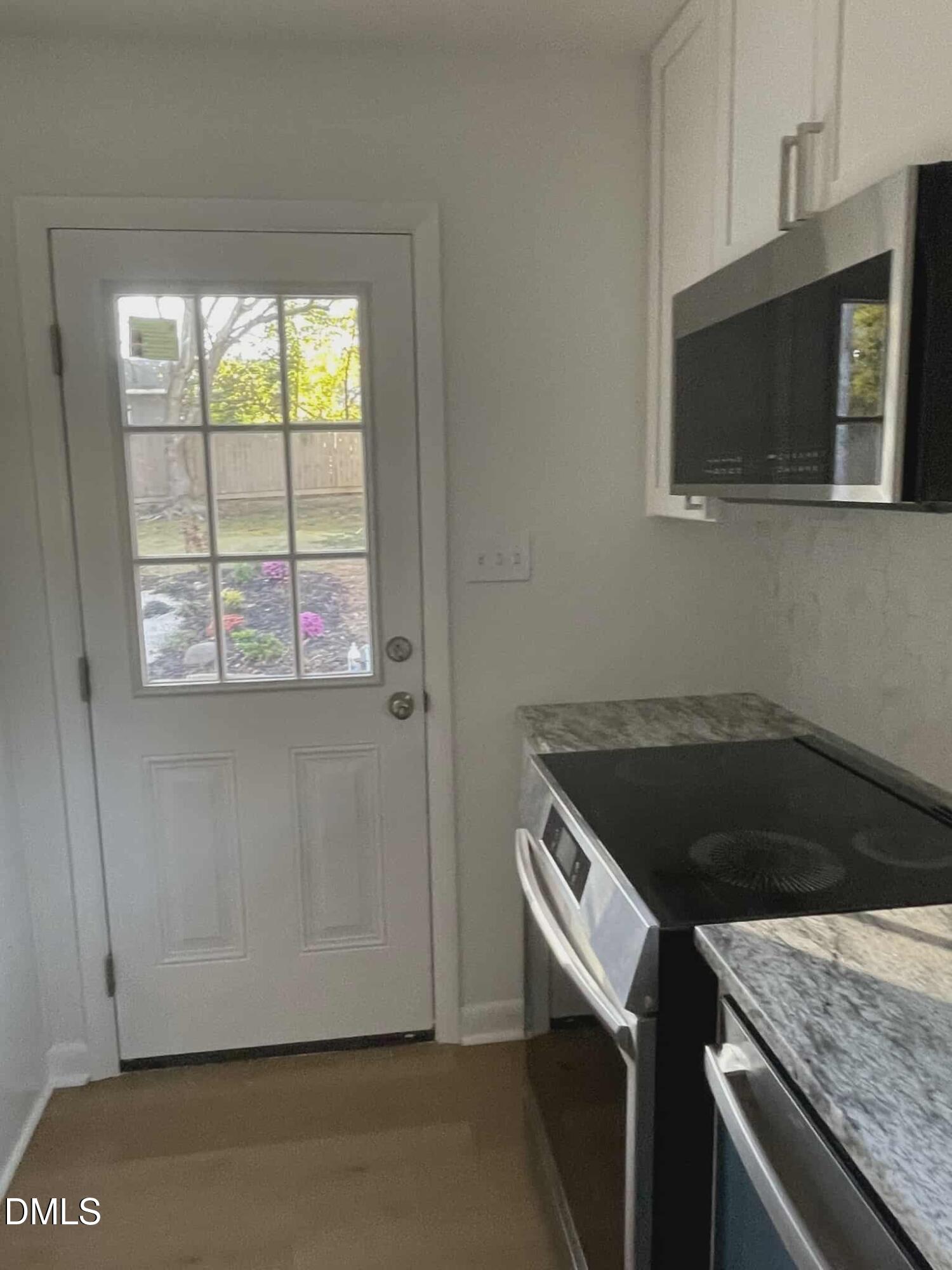 3415 Carolyn Drive Raleigh, NC 27604 - Photo 6 of 30 a kitchen with a stove and a microwave