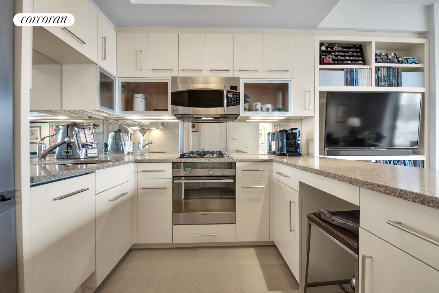 7 Beekman Place, Unit 14 Manhattan, NY 10022 - Photo 18 of 21 a kitchen with stainless steel appliances white cabinets and a stove