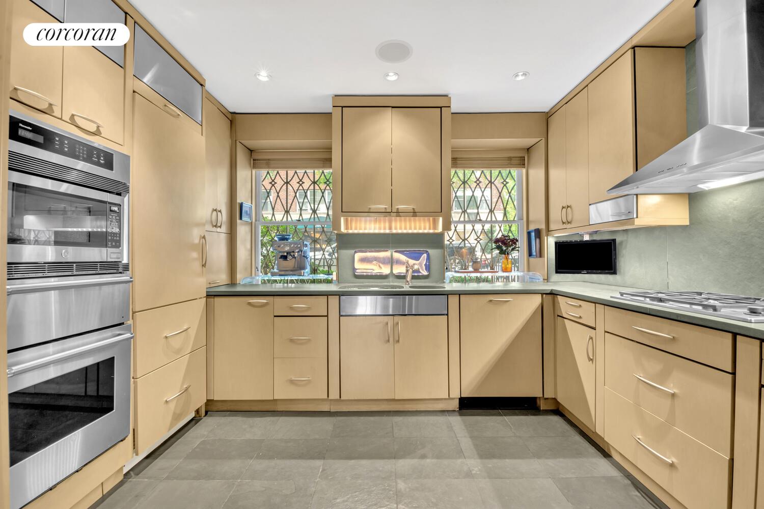7 Beekman Place, Unit 14 Manhattan, NY 10022 - Photo 6 of 21 a kitchen with stainless steel appliances granite countertop a sink and cabinets