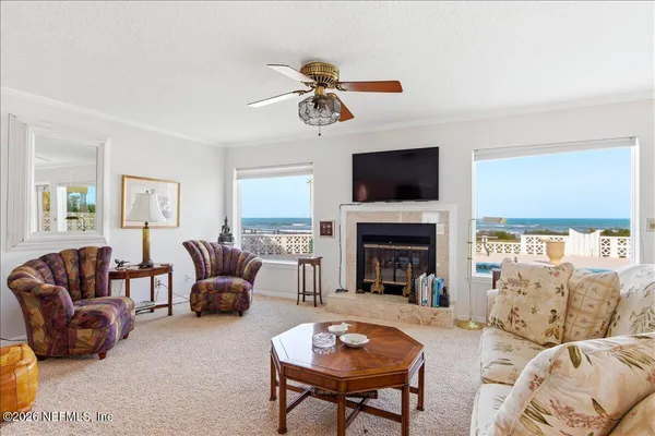 a dining room with furniture a chandelier and window