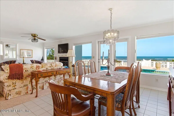 a view of a a dining room with furniture window and wooden floor