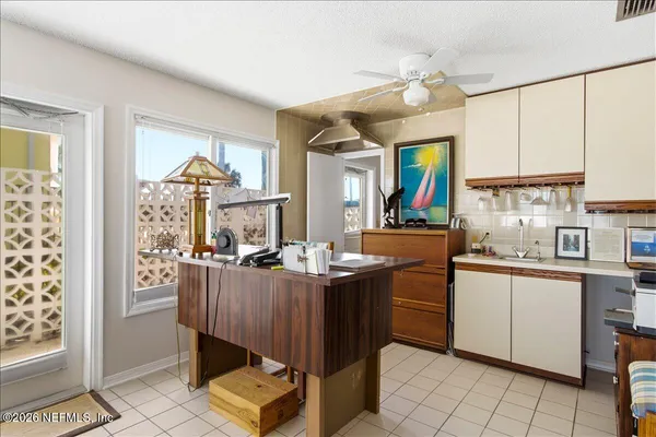 a bedroom with two beds and a large window