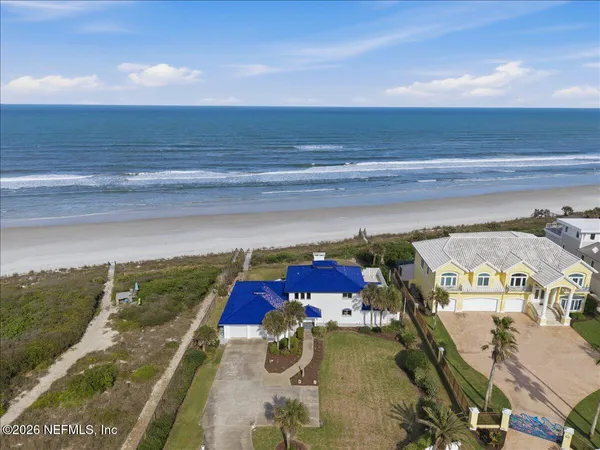 an aerial view of a house with a lake view