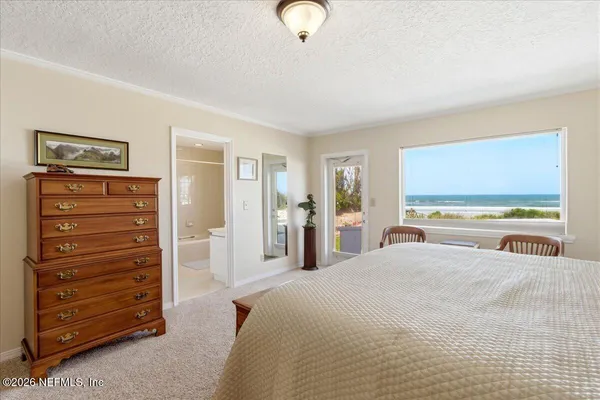 a bedroom with a bed and a ceiling fan