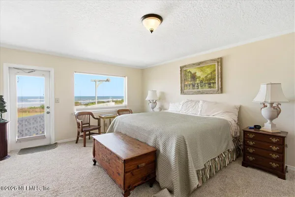 a bed room with a bed and a chandelier