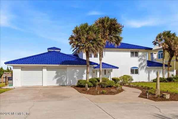 a view of a house with swimming pool and sitting area