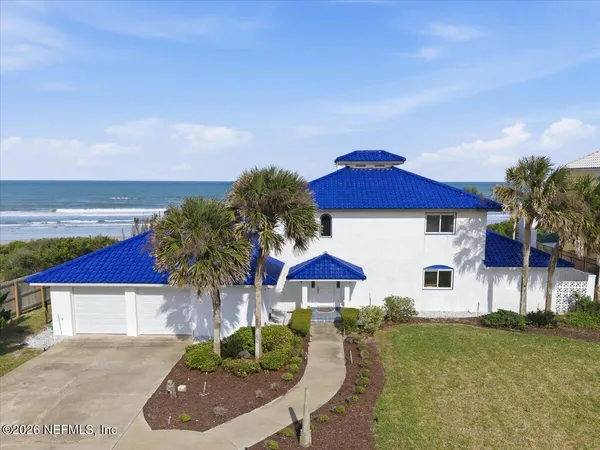 a view of a house with swimming pool and sitting area