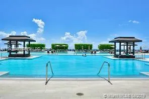 a swimming pool with outdoor seating and yard